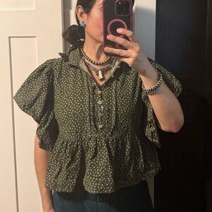 Green ruffle sleeve top with flower detail